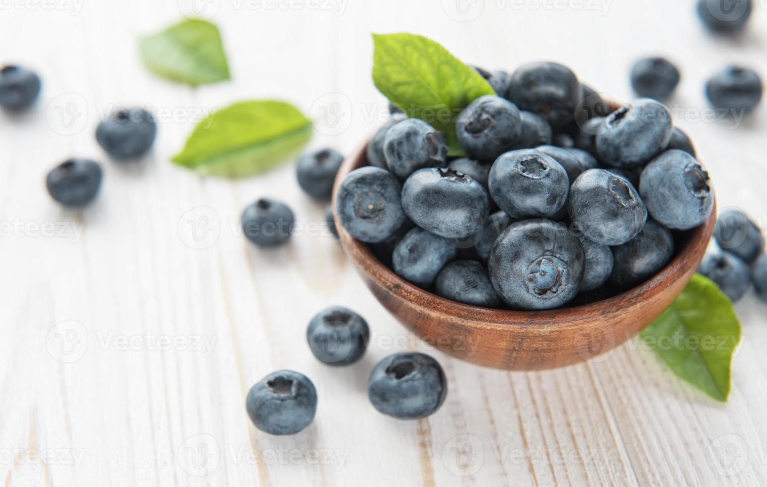 Blueberries on old wooden background photo