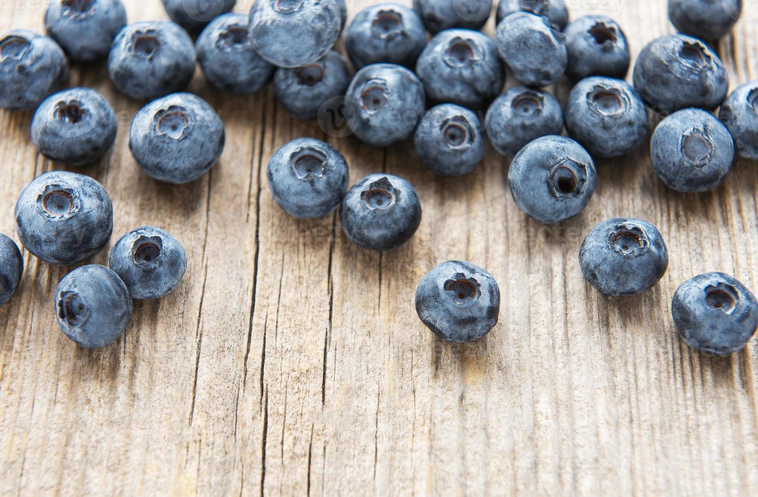 Blueberries on vintage wooden brown background photo