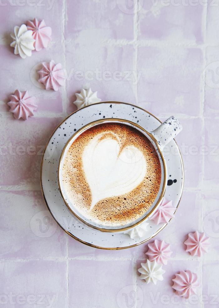 Cup with coffee and small meringues photo