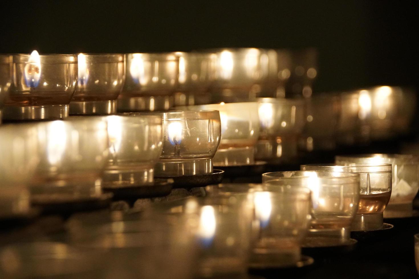 Lit candles in church photo