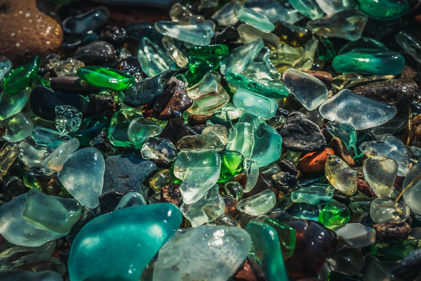 Natural background with sea glass close-up on sand. photo