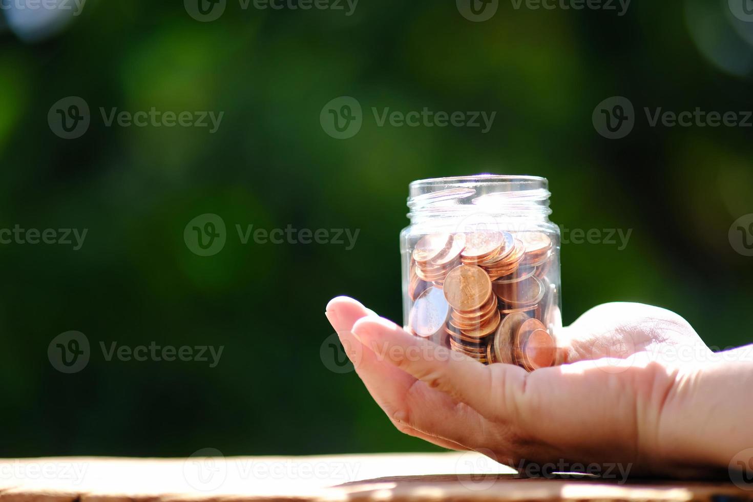 Coins on table background and saving money photo