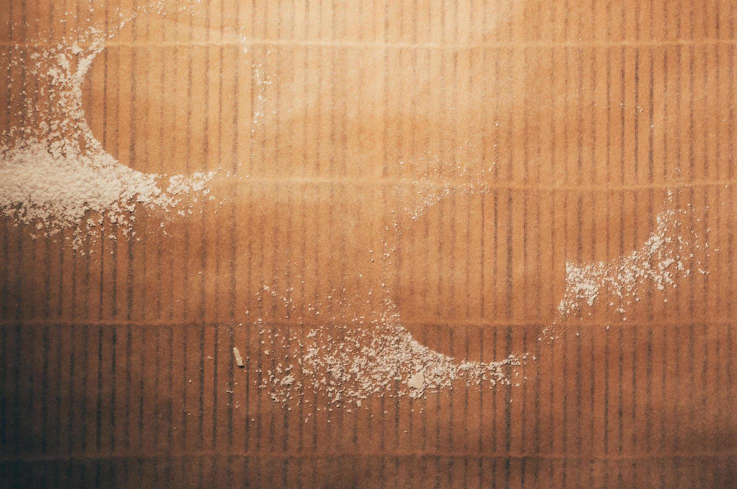 Empty space from round cookies formed by flour on table photo