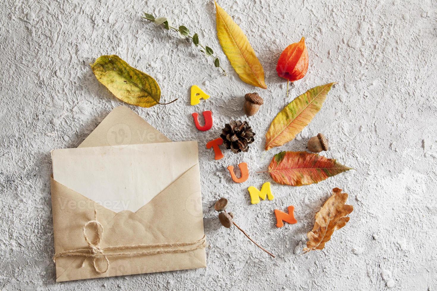 Top view of layout with word autumn, envelope photo