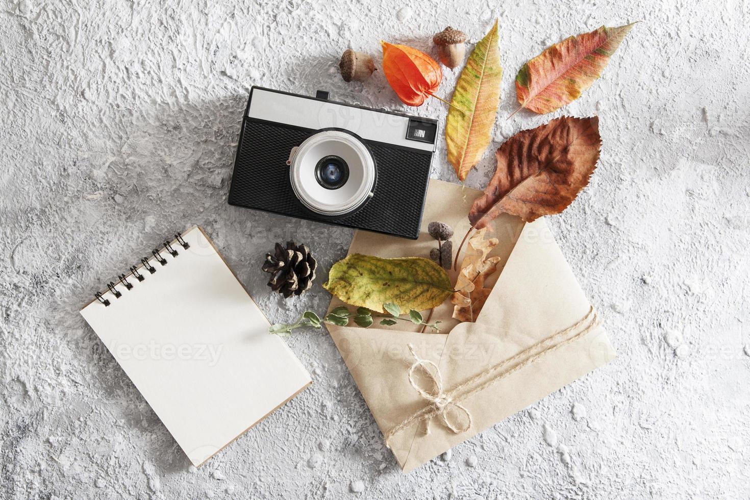 Autumn flat lay layout with vintage camera, envelope photo