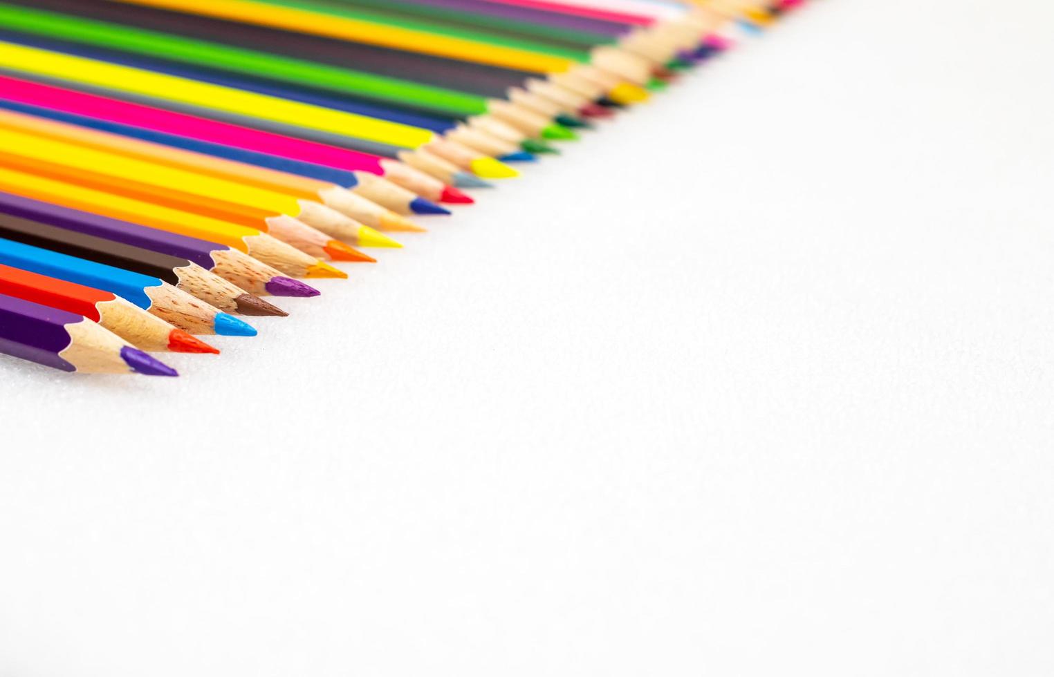 Colour pencils on white background close up photo