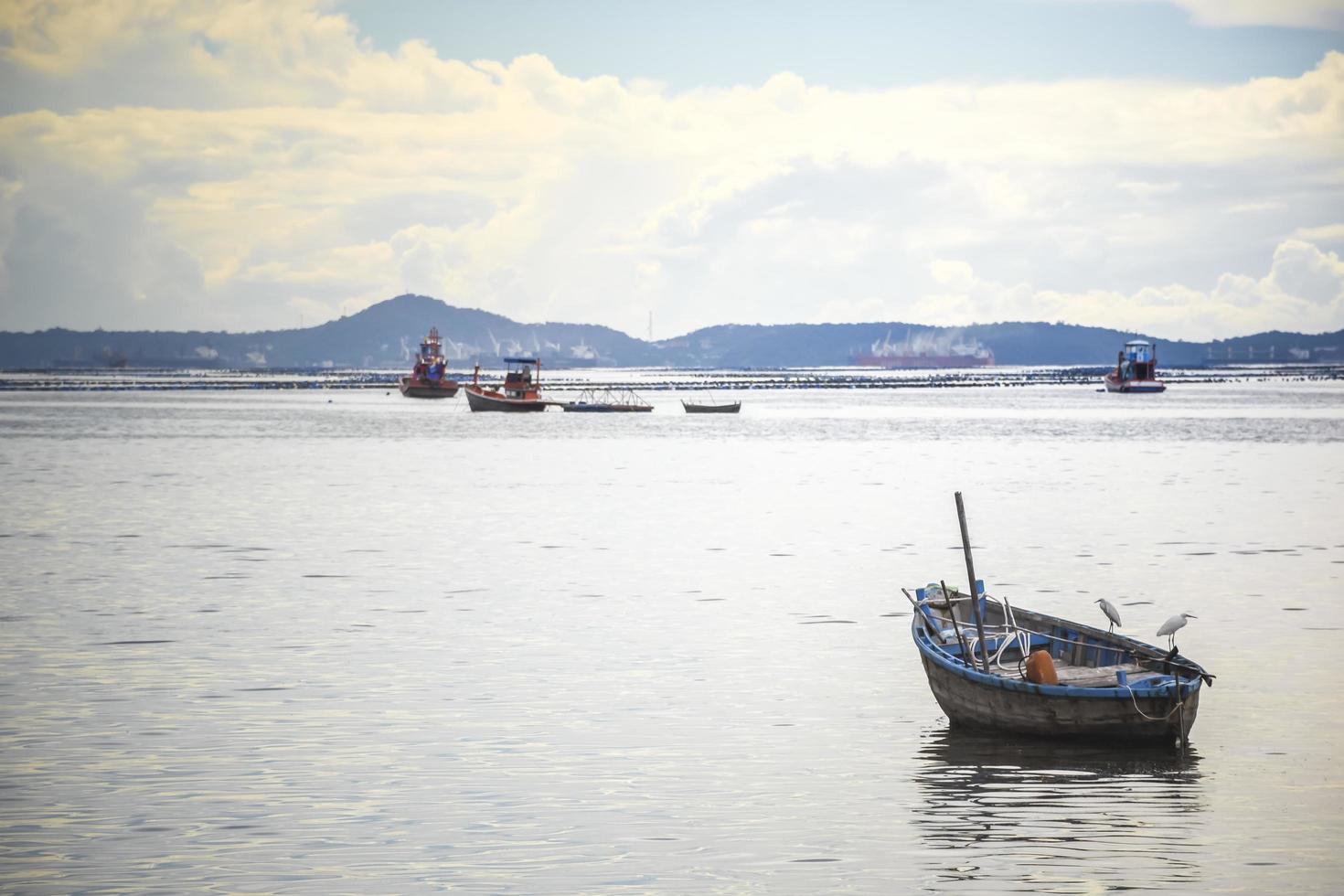 Fish boat in the sea and mountain photo