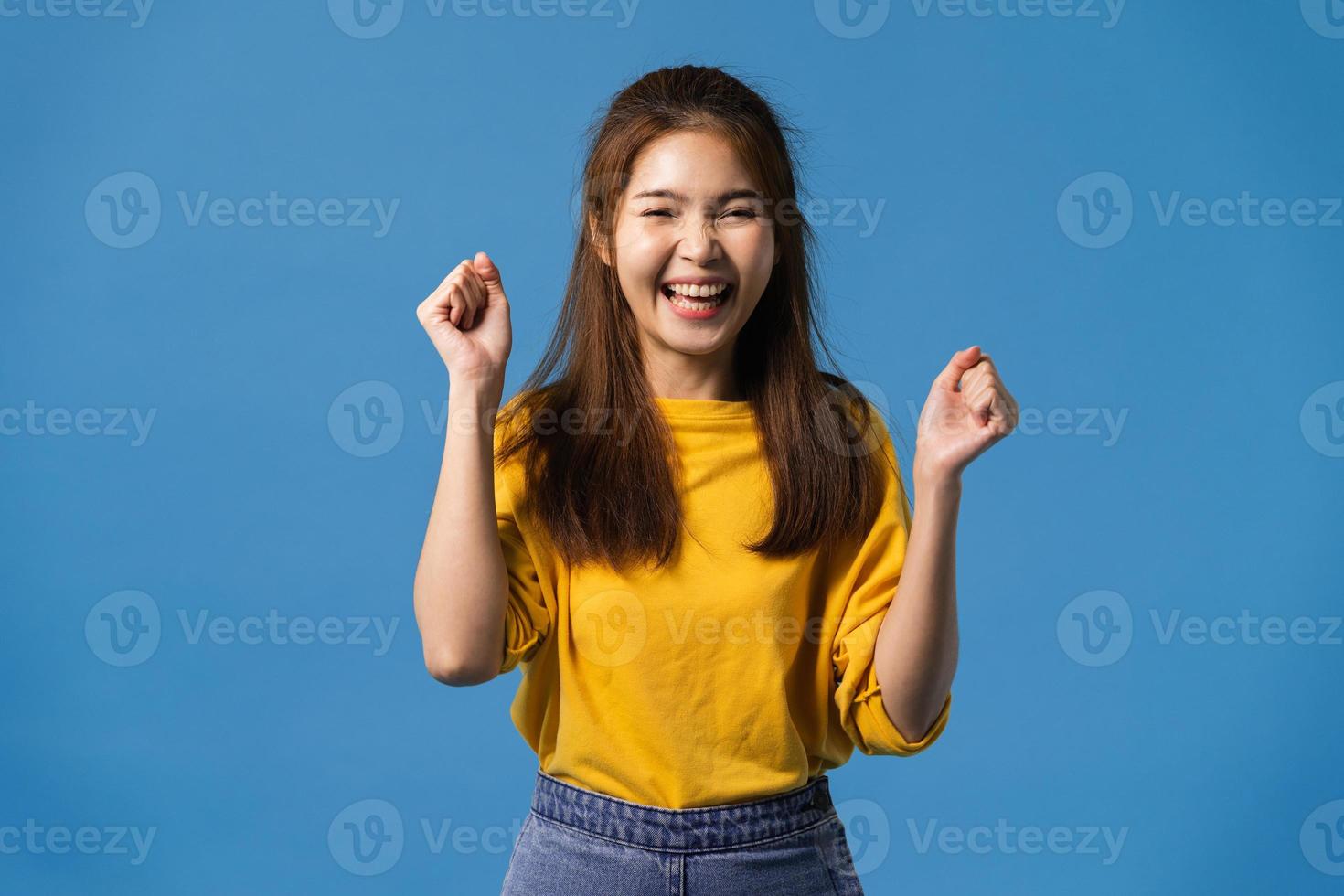 Young Asian lady joyful and exciting on blue background. photo