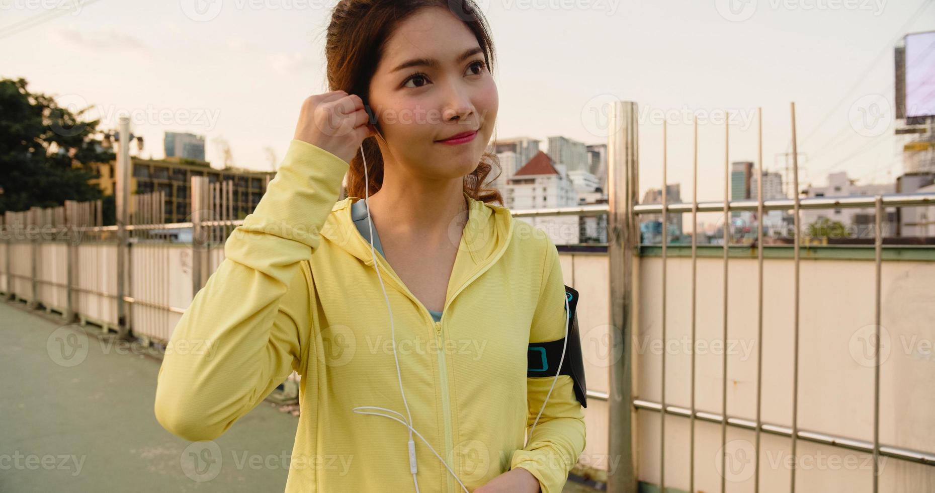 Asia athlete lady exercises using smartphone for listen to music. photo