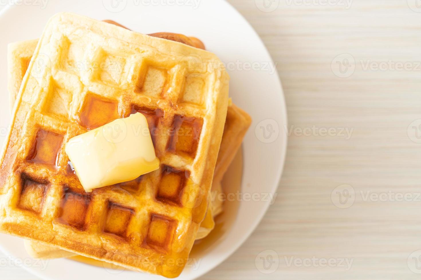 Waffle stack with butter and honey photo