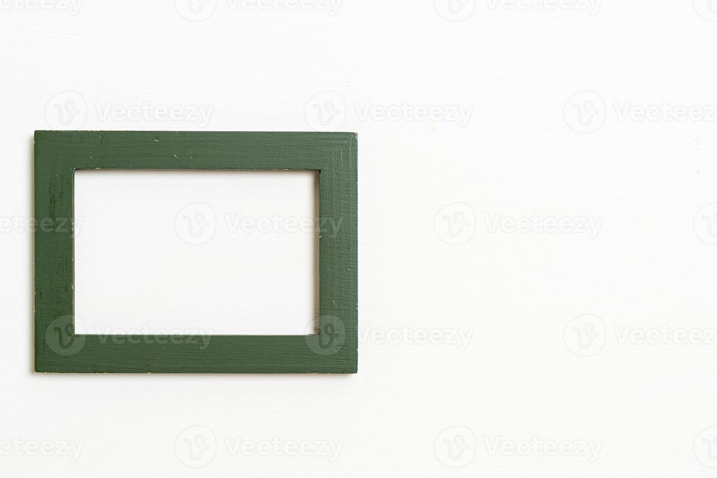 Empty picture frame on white wall background photo