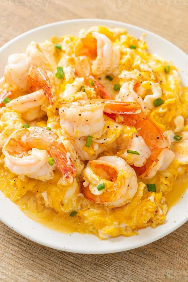 Creamy omelet with shrimps or scrambled eggs and shrimps photo