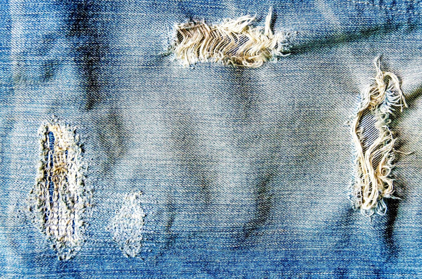 Blue jeans lack and jeans texture on the wooden floor photo