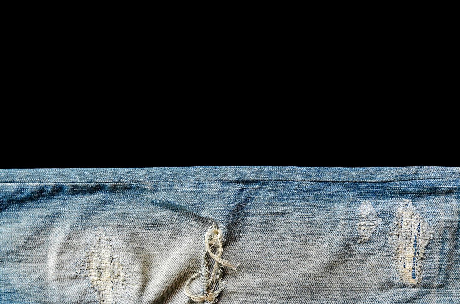 Blue jeans lack and jeans texture on the wooden floor photo