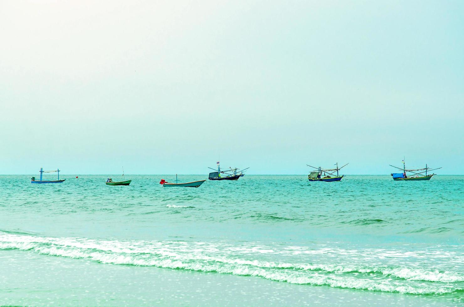 The sand beach and sea with boat that parked on the beachfront. photo