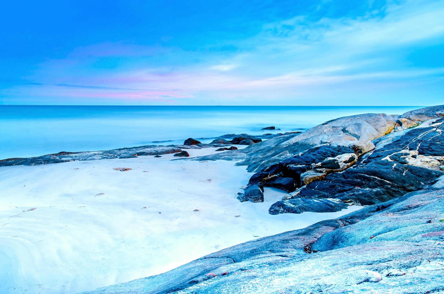 The view of the sand beach and sea wave with rock and reef on morning photo