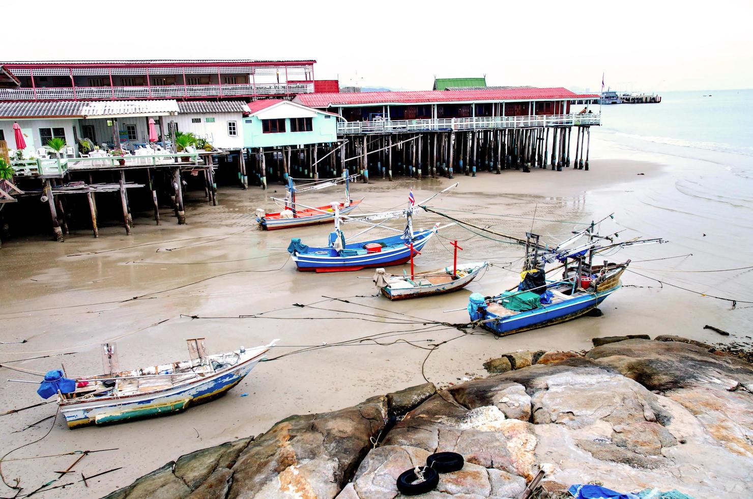 The sand beach and sea with boat that parked on the beachfront. photo