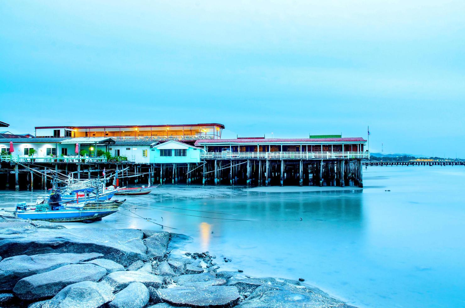 la vista de la playa de arena y las olas del mar con rocas y arrecifes en la mañana foto