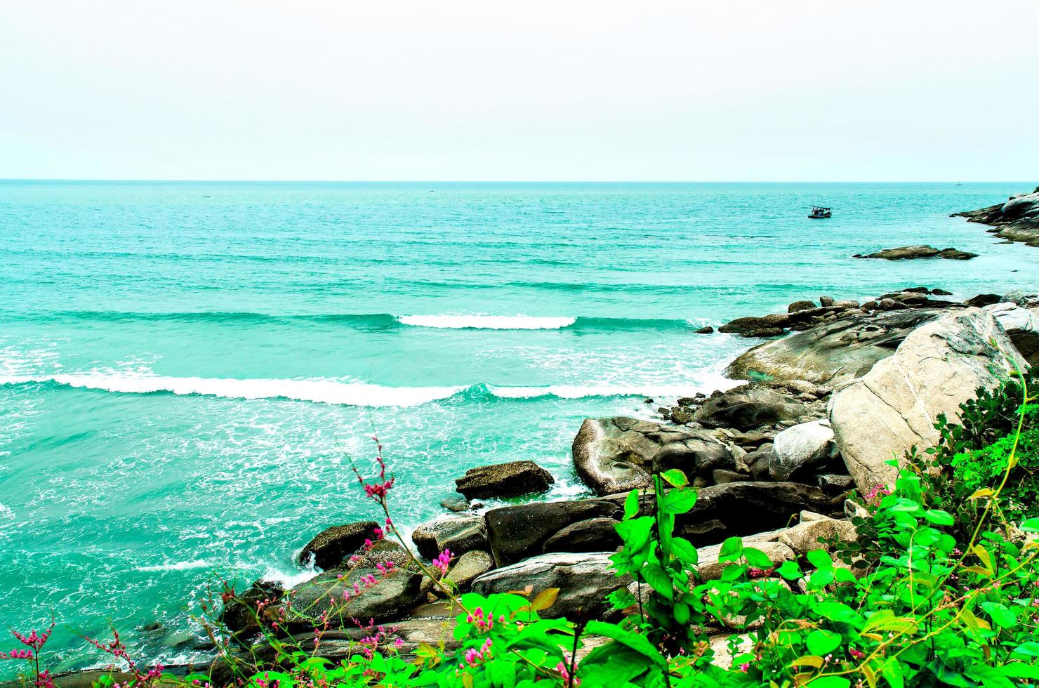 The view of the sand beach and sea wave with rock and reef on morning photo