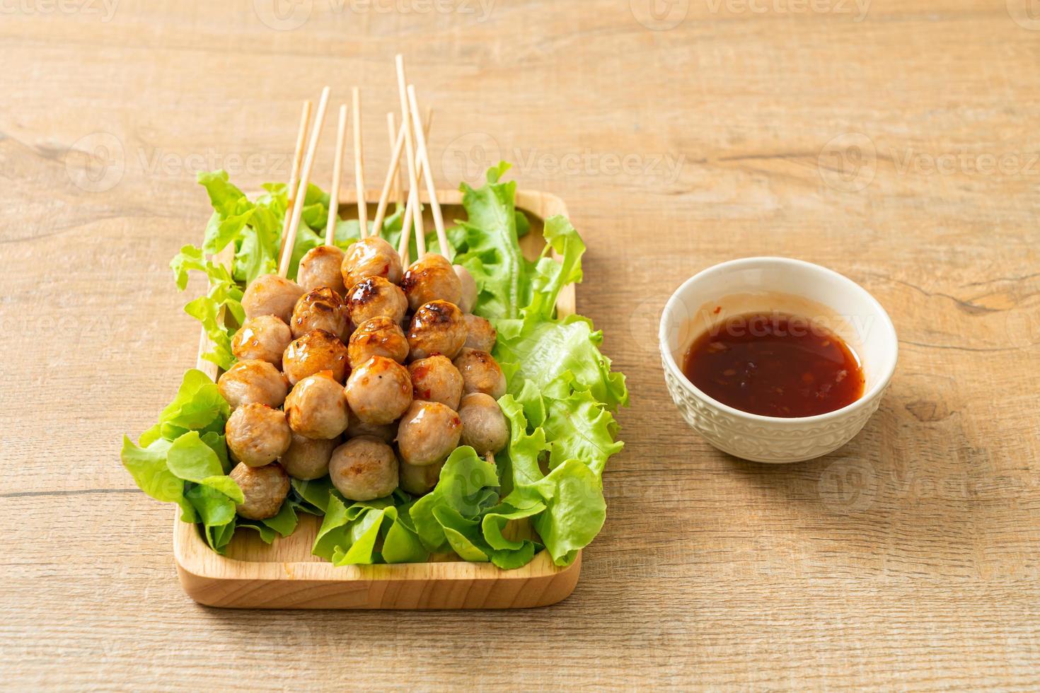 Grilled meatballs skewer with spicy sauce photo