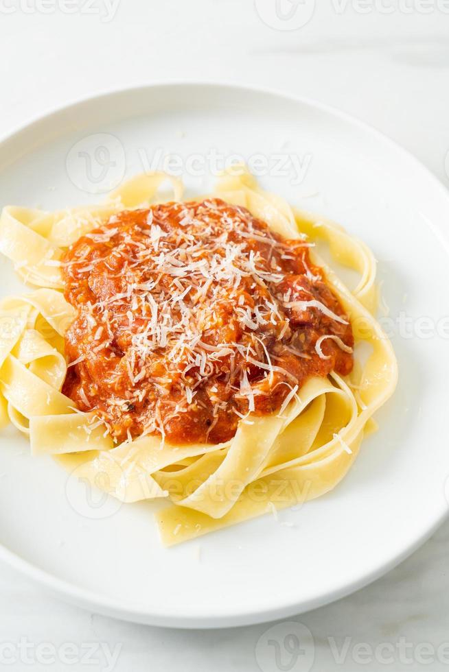 Pork bolognese fettuccine pasta with parmesan cheese photo