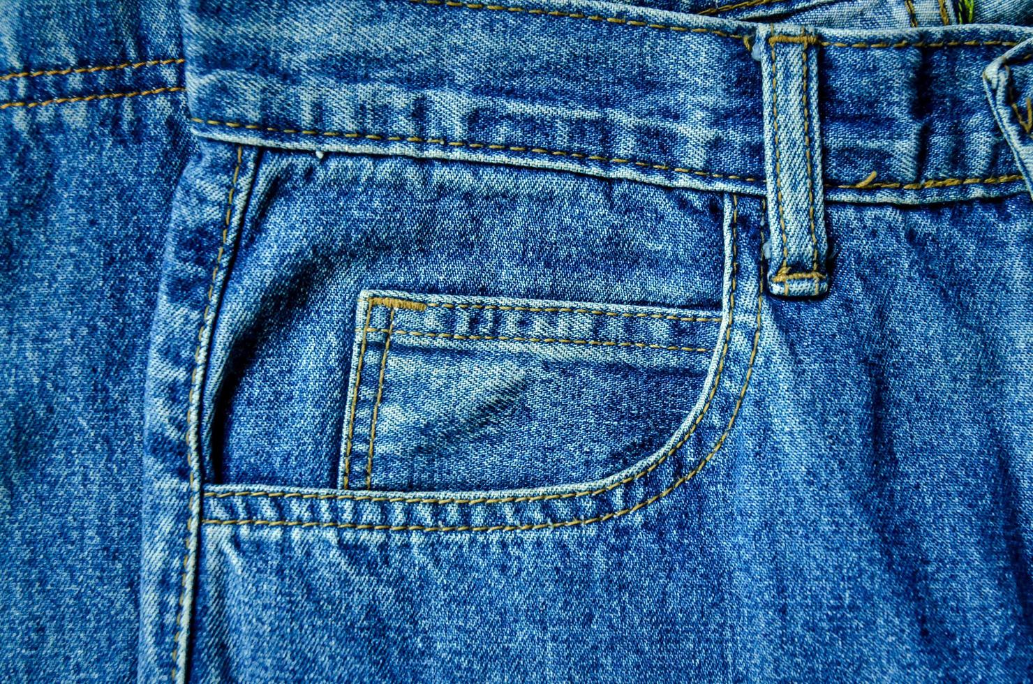 Blue jean and jean lack texture on table, Jeans are overlapping. photo