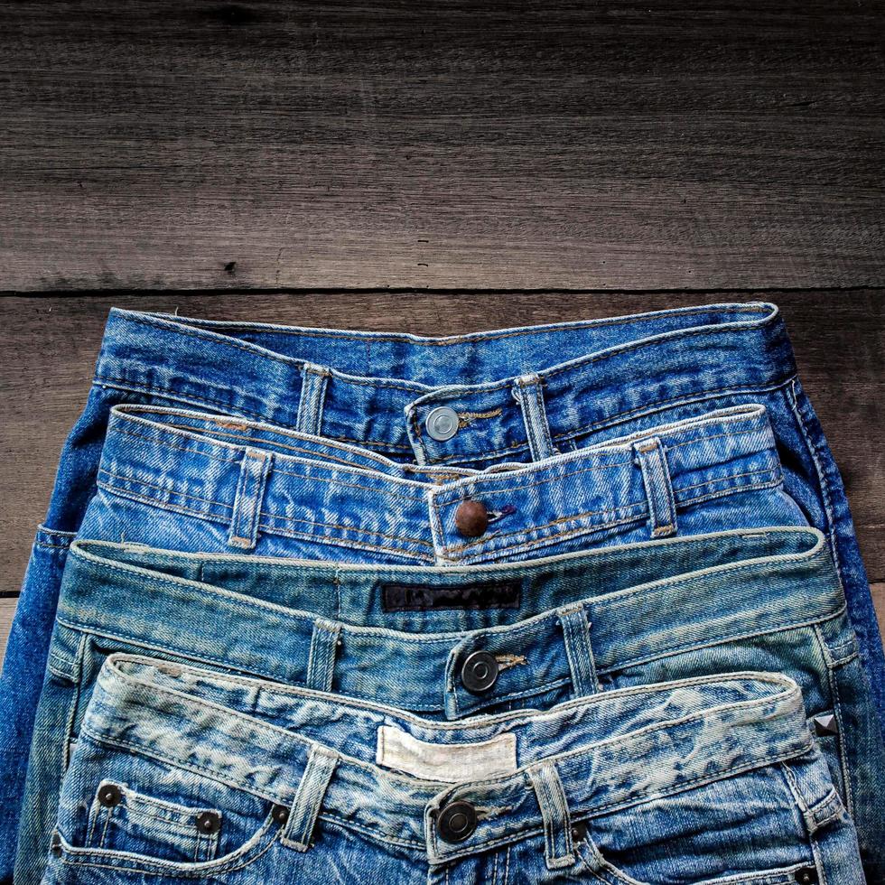 Blue jean and jean lack texture on table, Jeans are overlapping. photo