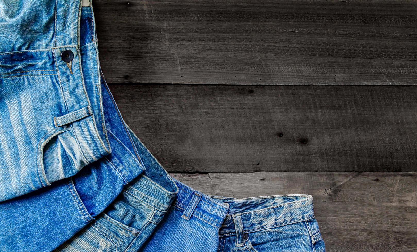 Blue jean and jean lack texture on table, Jeans are overlapping. photo