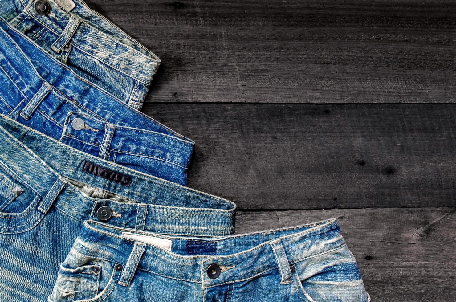 Blue jean and jean lack texture on table, Jeans are overlapping. photo