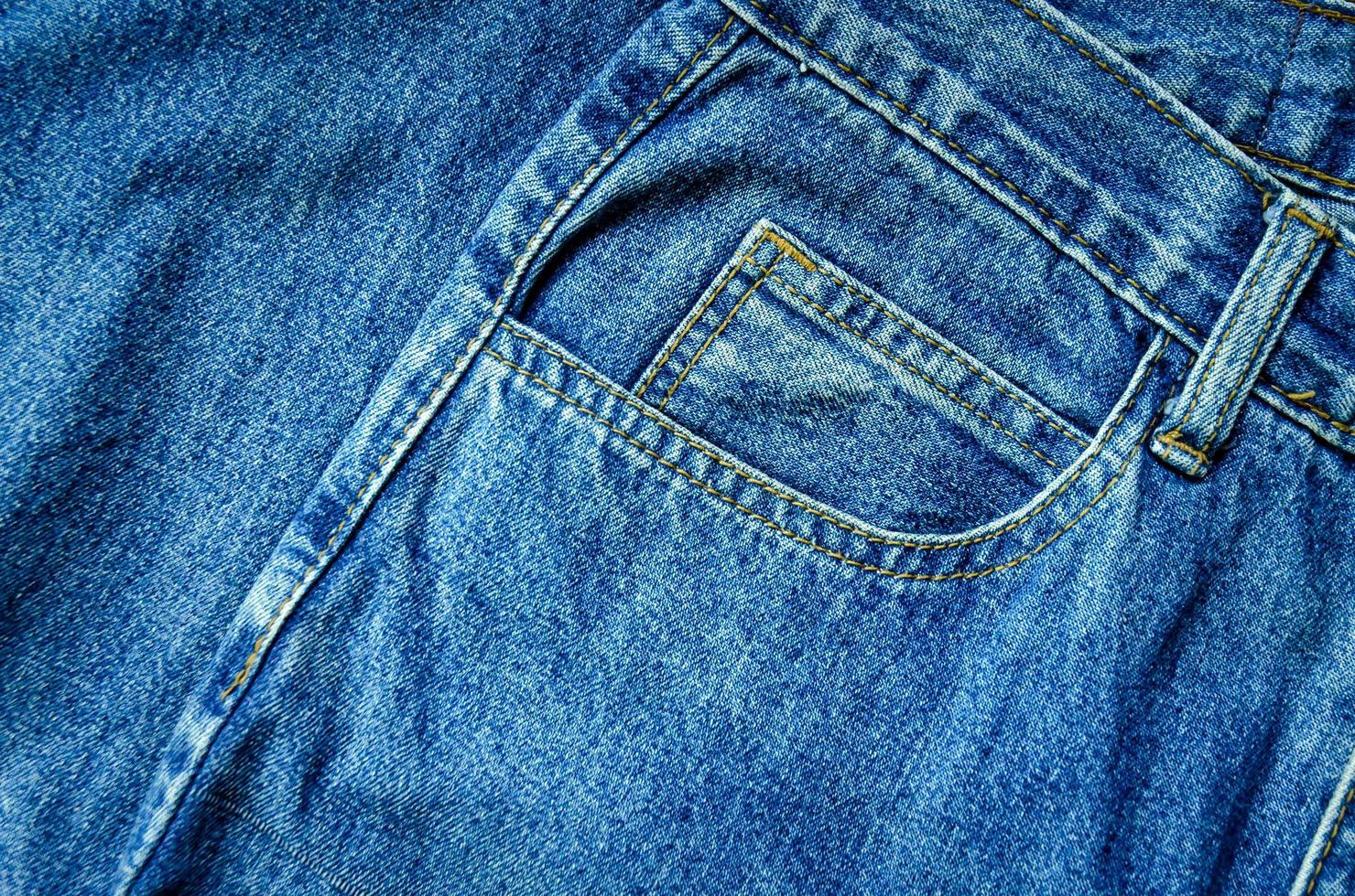 Blue jean and jean lack texture on table, Jeans are overlapping. photo