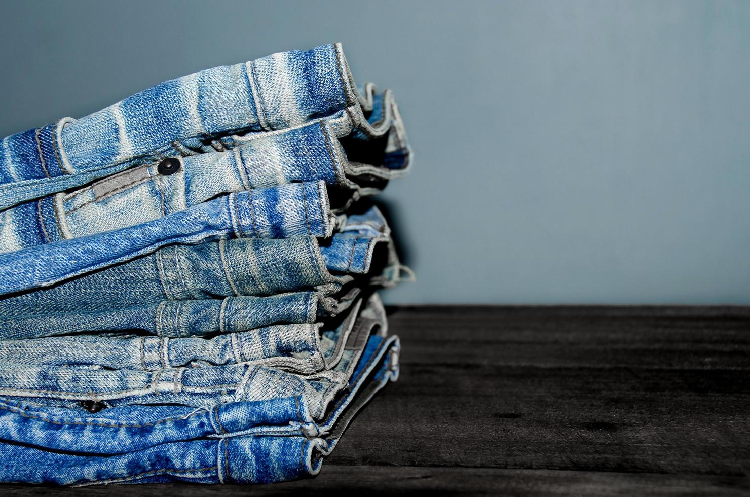 Blue jean and jean lack texture on table, Jeans are overlapping. photo