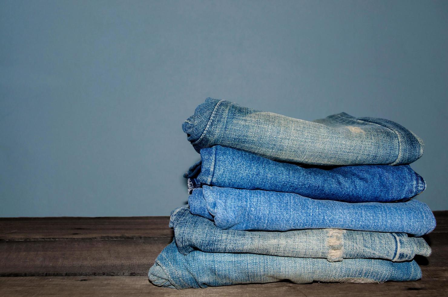 Blue jean and jean lack texture on table, Jeans are overlapping. photo