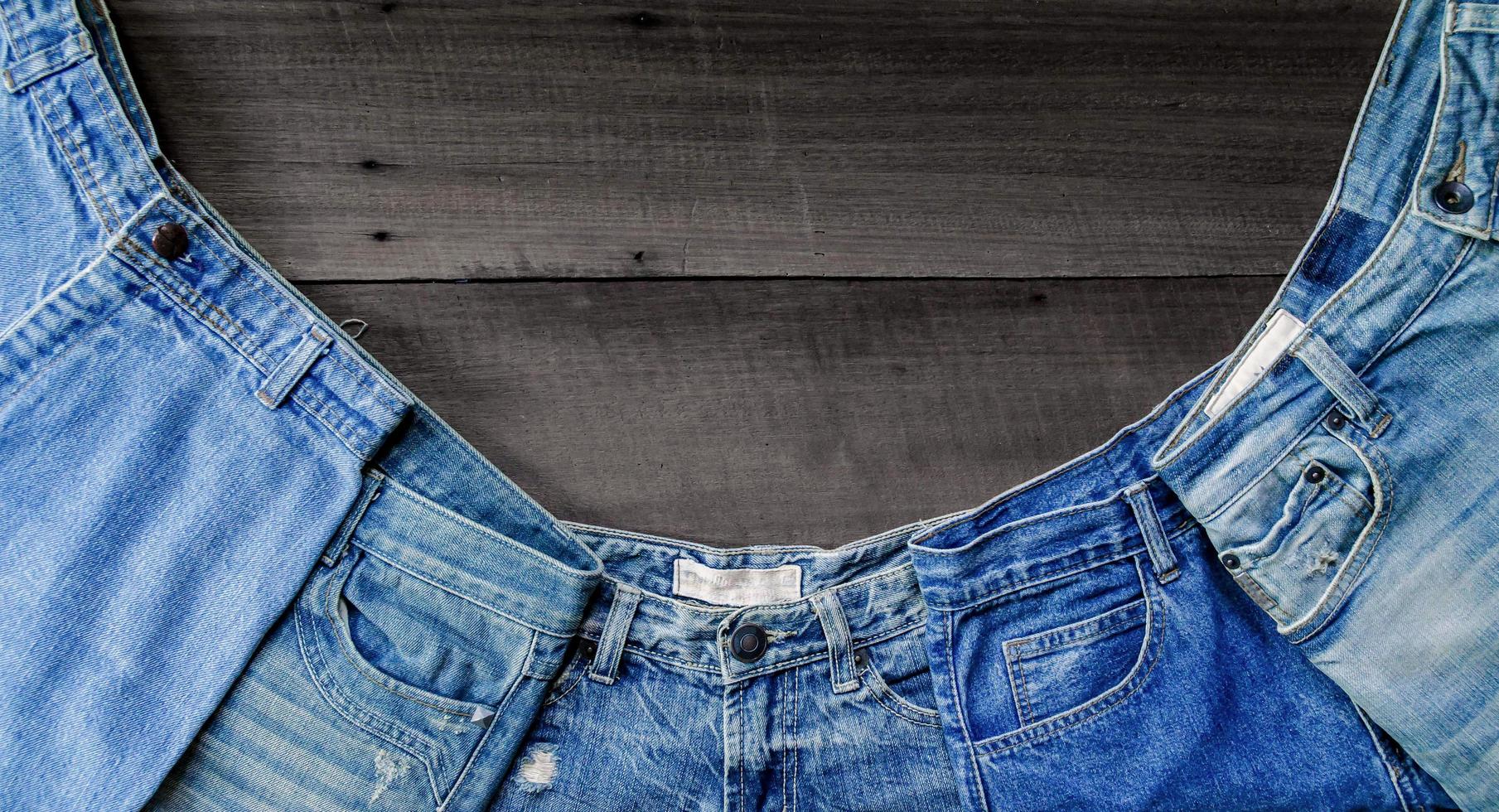 Blue jean and jean lack texture on table, Jeans are overlapping. photo