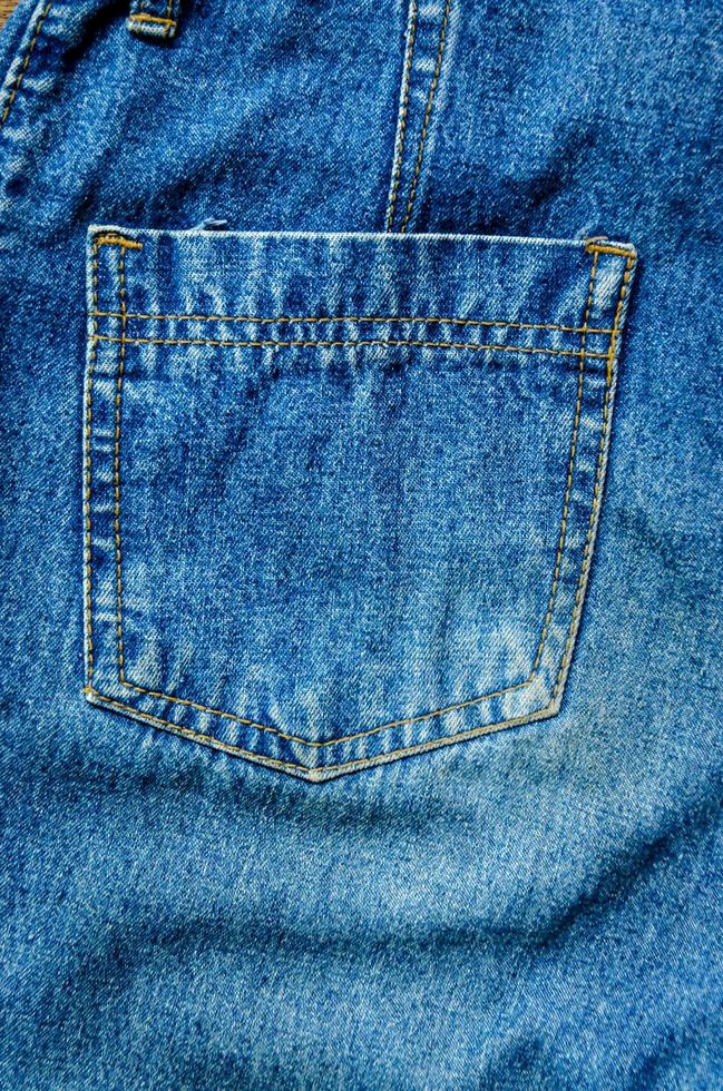 Blue jean and jean lack texture on table, Jeans are overlapping. photo