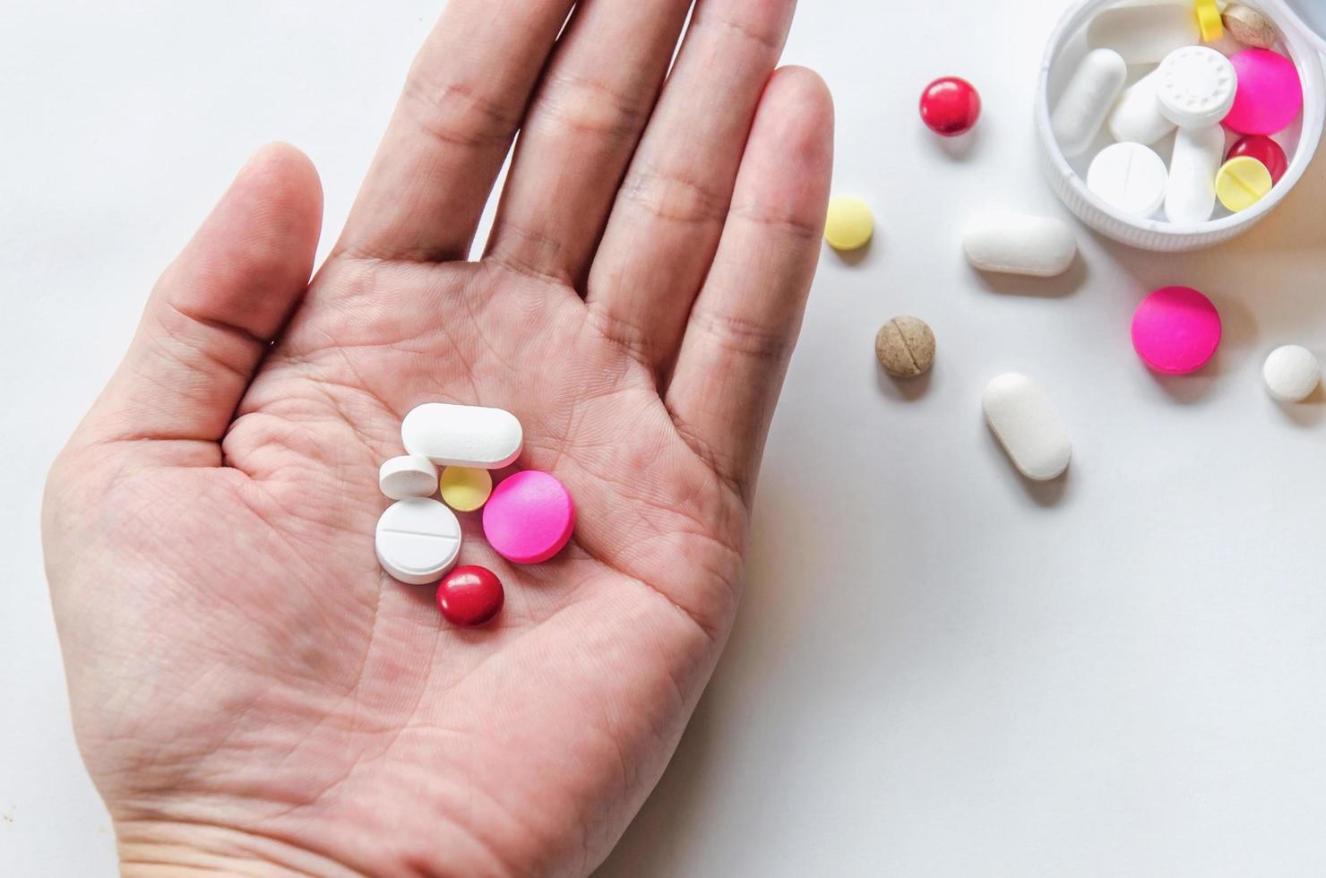 Hand hold the pills and drug, Pile of the drug and pills on the hand. photo