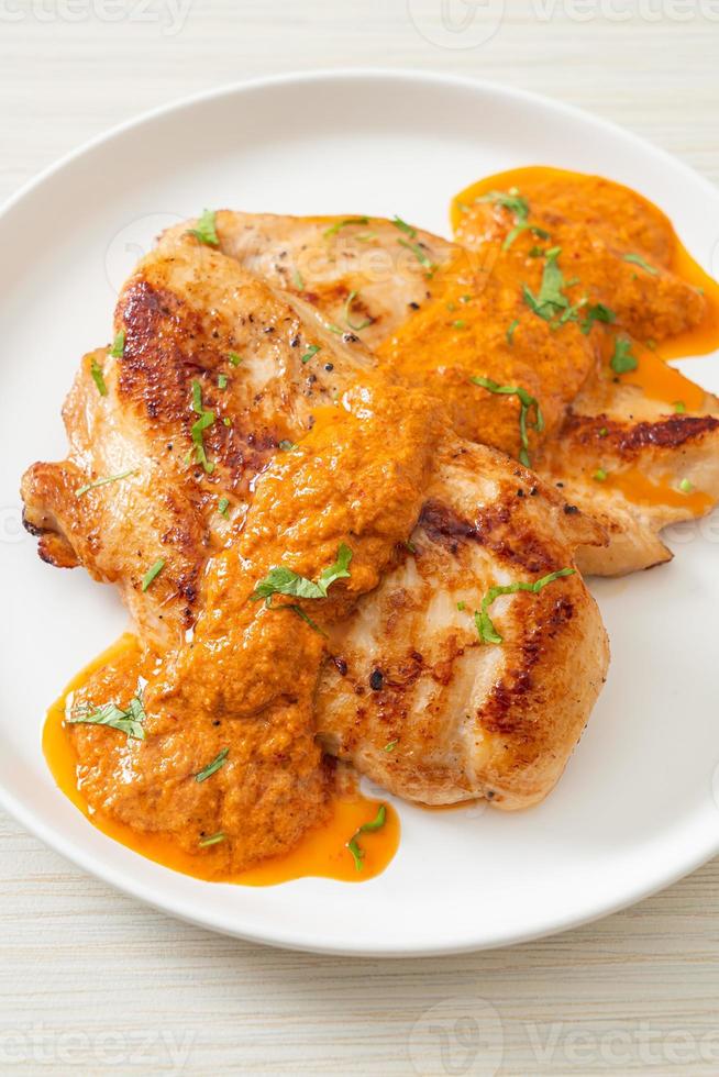 Grilled chicken steak with red curry sauce and rice photo