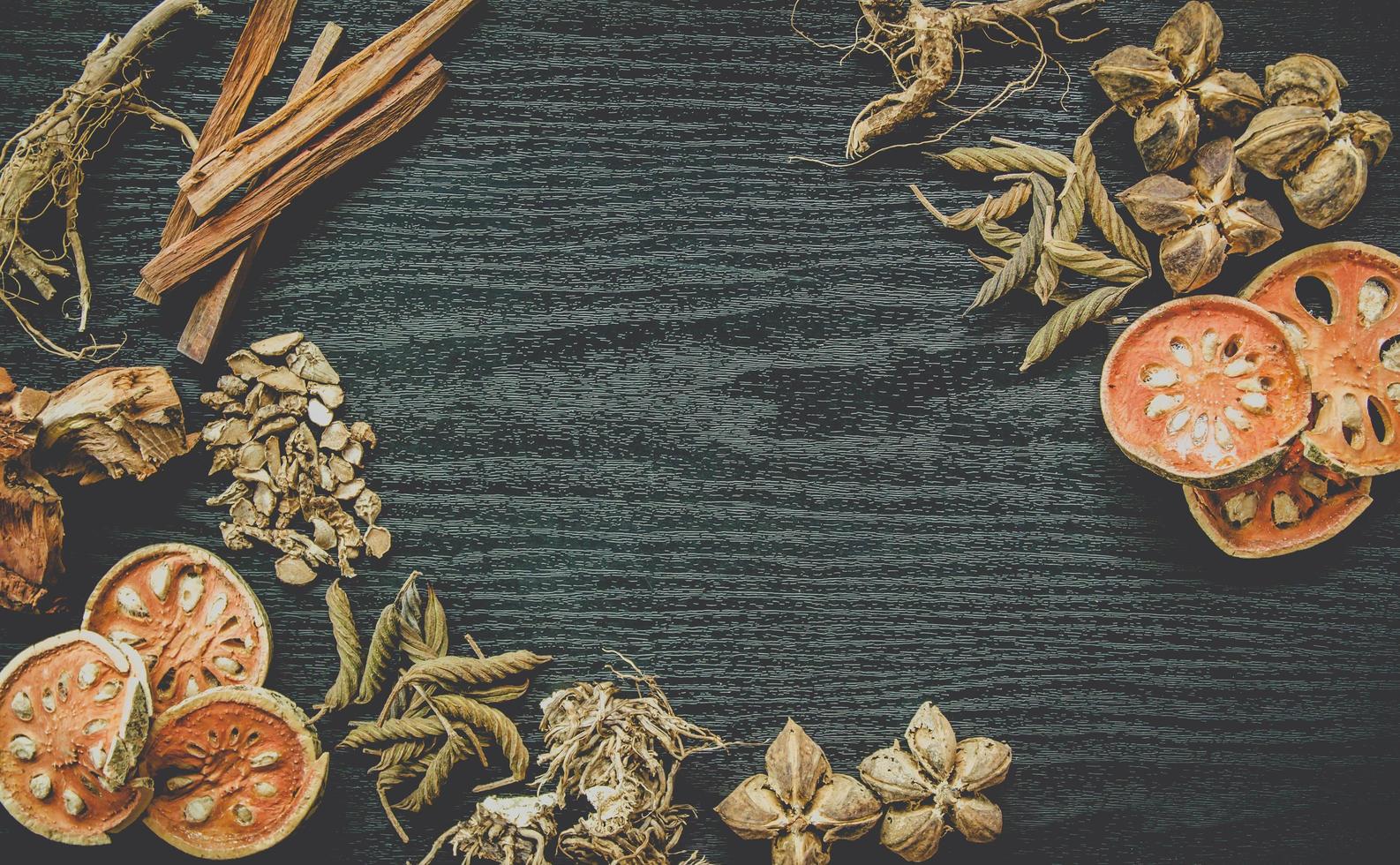 Dried herbs and dried bael fruit, Slices of bael fruit on table. photo