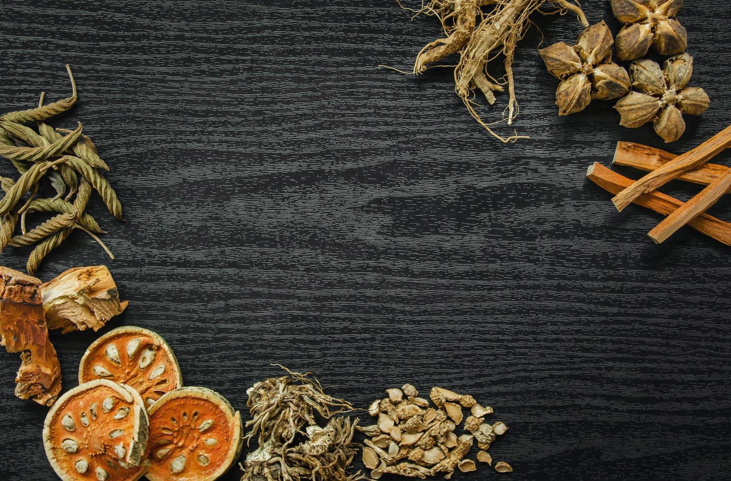 Dried herbs and dried bael fruit, Slices of bael fruit on table. photo