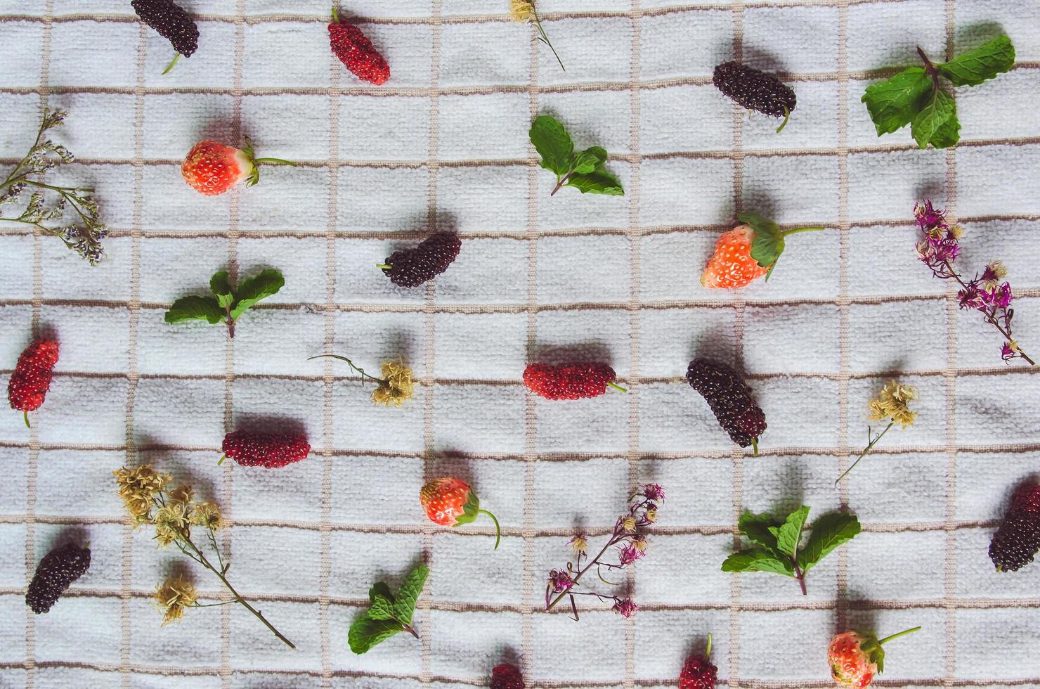 Mulberry fruit and strawberry, Fresh berry fruit on white fabric. photo