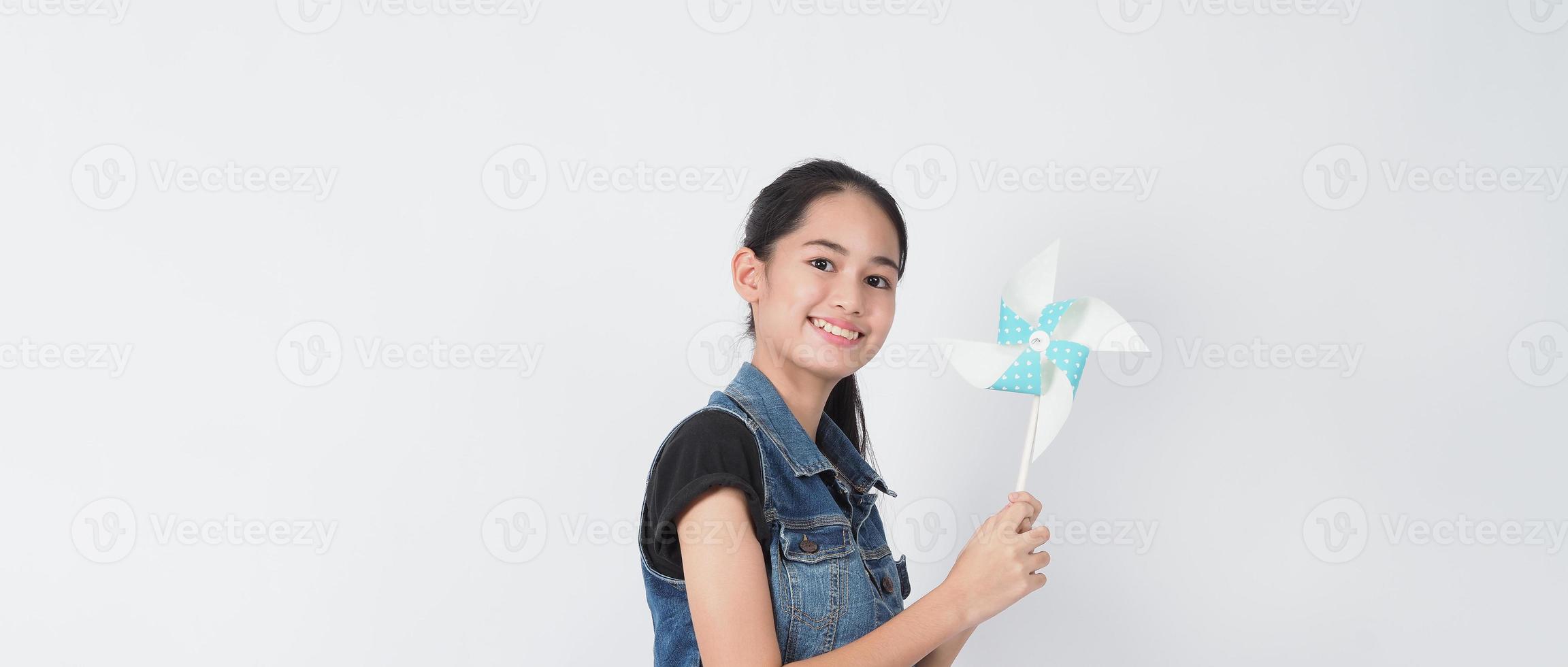 Teenage woman and paper windmill toys photo