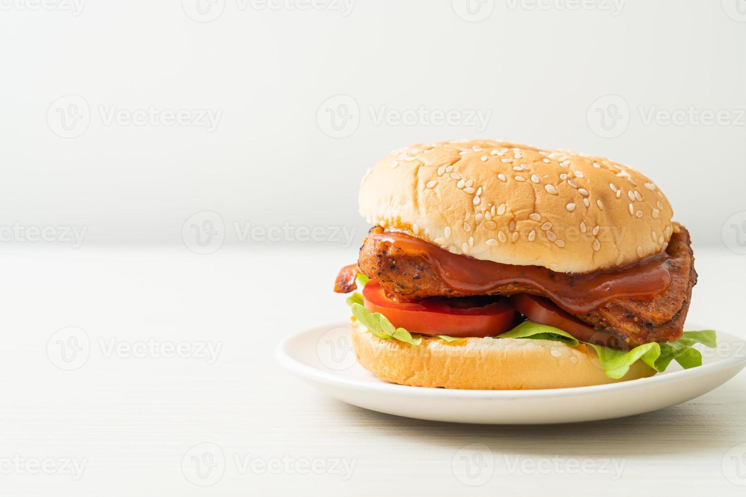 Grilled chicken burger with sauce on plate photo