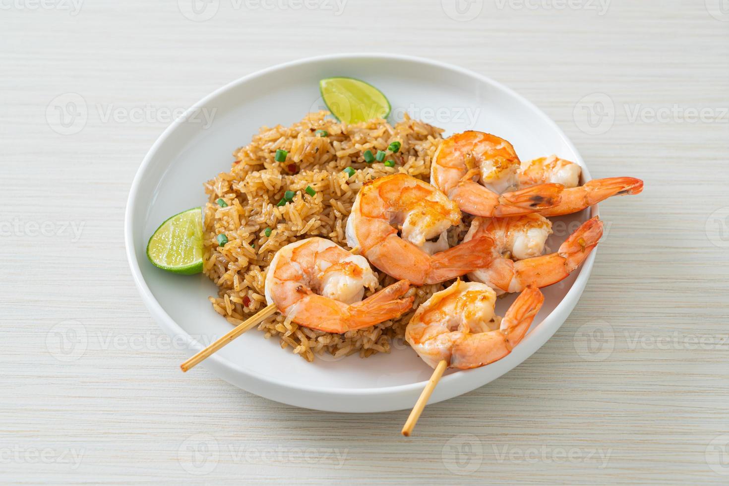 Fried rice with shrimps skewers photo