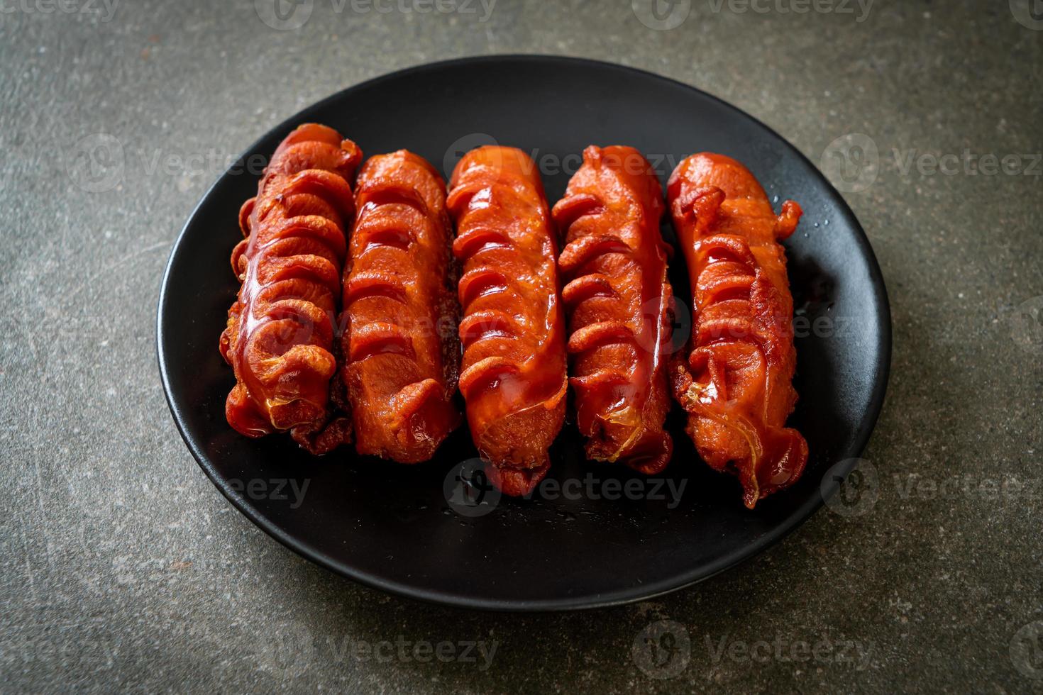 Deep fried sausage skewer on plate photo