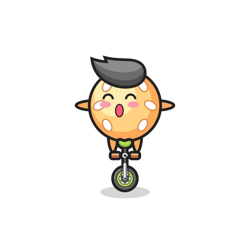 The cute sesame ball character is riding a circus bike vector