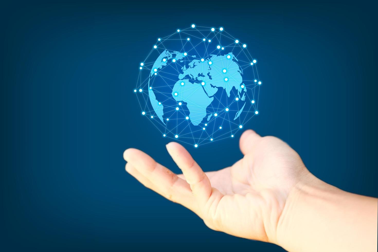 Business hand holding earth globe on blue  background photo