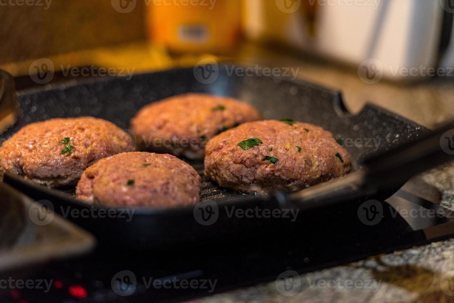 hamburguesas a la parrilla con llamas danzantes cocinadas a la perfección foto