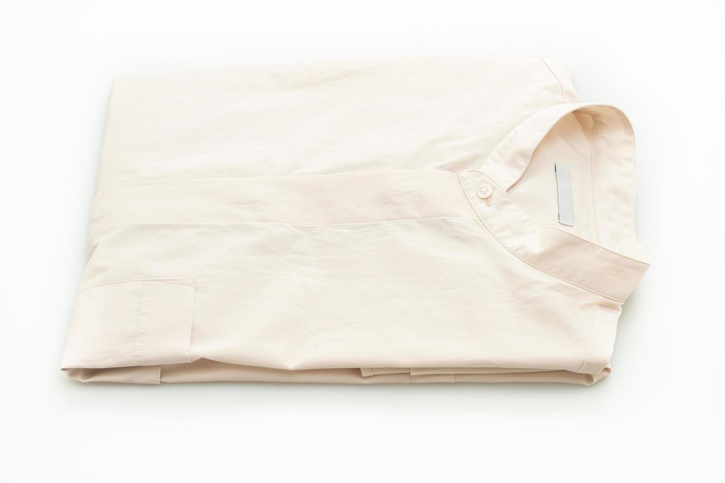 Beige shirt fold on white background photo
