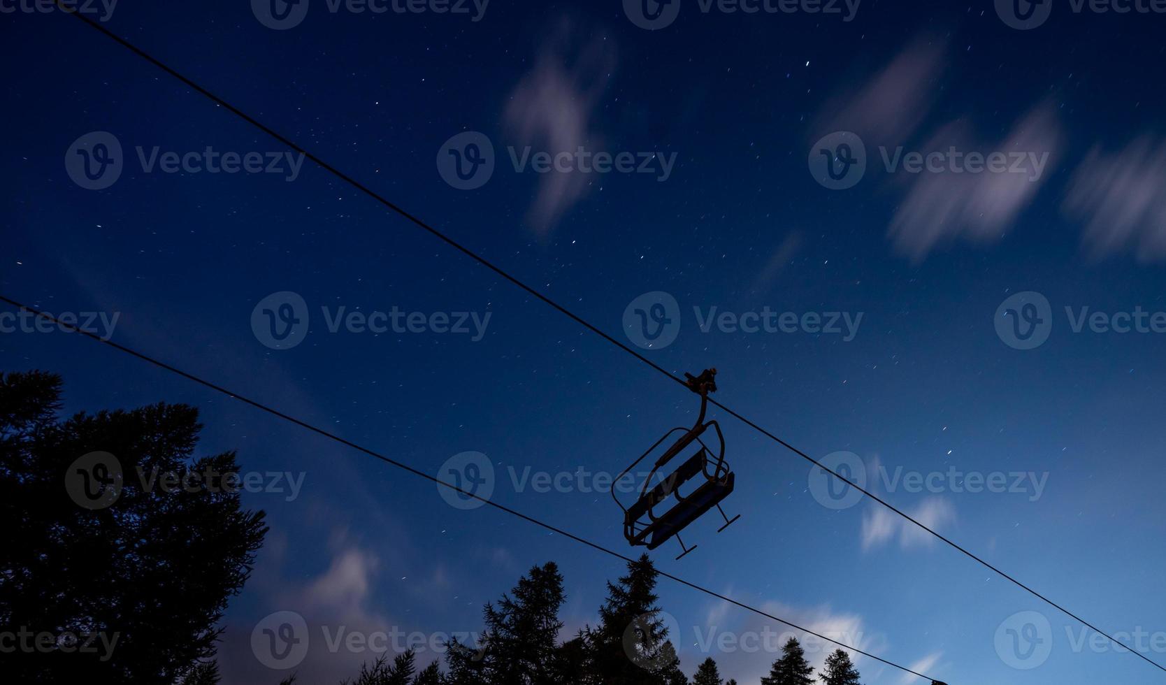 Chair lift under a starred summer sky photo