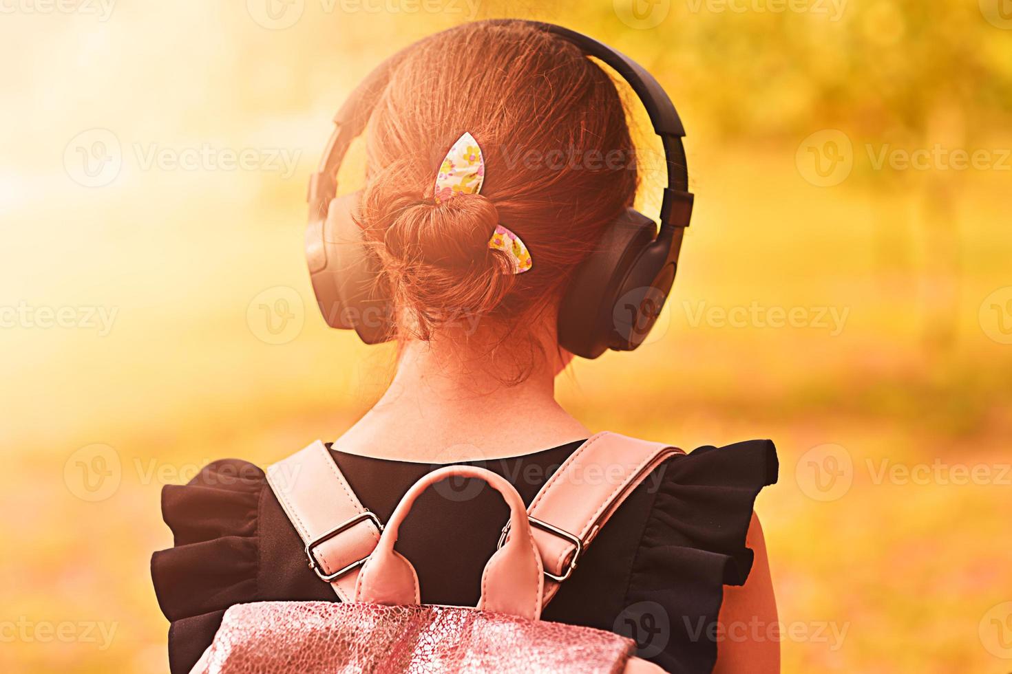 Girl wearing headphones. Headphones with wireless technology. photo