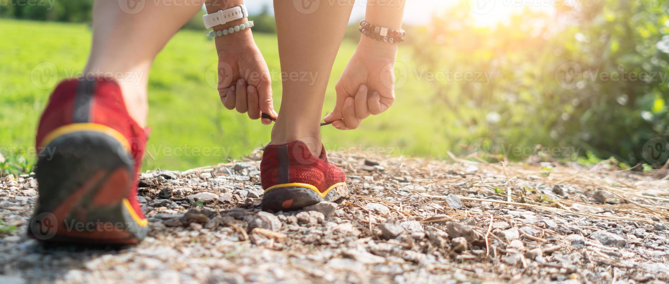 Woman wear running shoe on to walking. photo